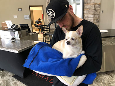 A man and his dog receiving help after the fire