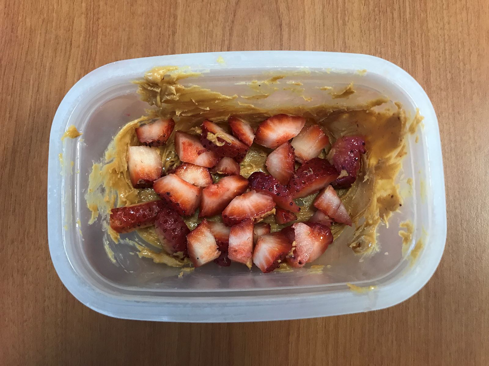 strawberries on peanut butter in tupperware
